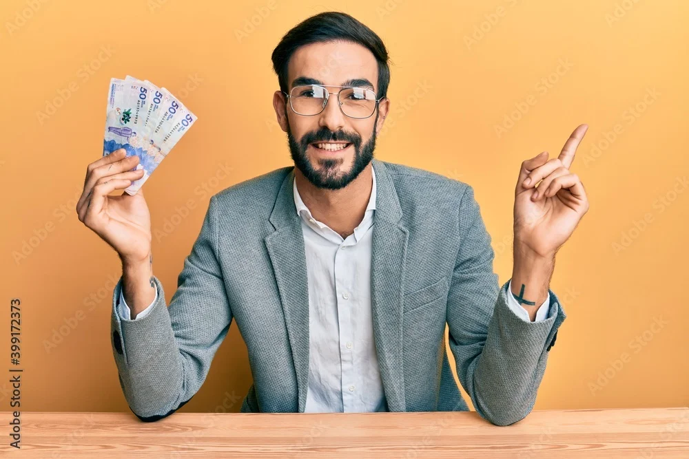 Argentine Economist folding money on right hand and other hand pointing up