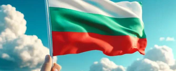 Fand holding Bulgarian flag with clouds and open sea background